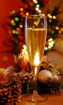 glass of champagne over new year decoration