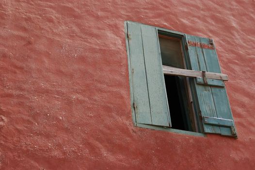 wood window detail on red wall