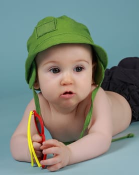 adorable 8 months cacasian baby boy playing with sunglasses