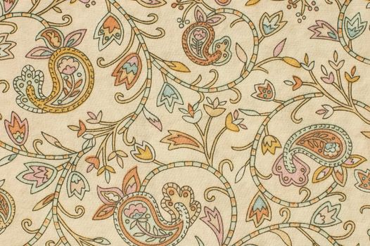colorful paisley print fabric background on a foundation of beige