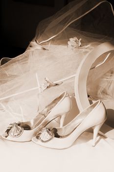 Wedding shoes, box and veil in sepia