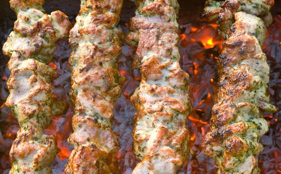 Shish kebab preparation on campfire