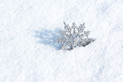 beautiful silver snowflake in snow