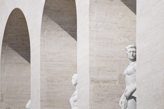 Squared colosseum detail with marble statue - Eur zone - Rome Italy.