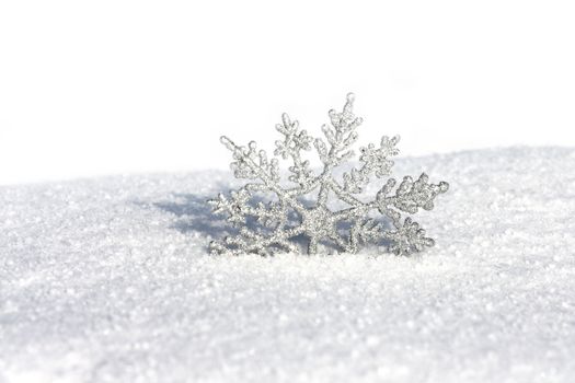 beautiful silver snowflake in snow