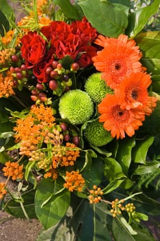 Bouquet of flowers in red, orange and green colors-vertical 