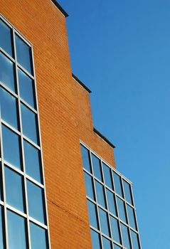 brick and glass architecture against blue sky