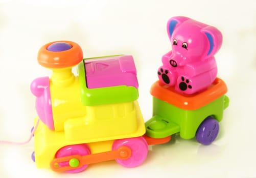 plastic toy train with a small teddy 