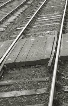 vintage railroad tracks with a narrow pedestrian crossing