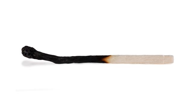 Macro view of burnt match isolated over white