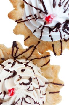 Top view of cakes with whipped cream isolated over white