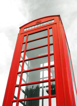 iconic british red telephone box abstract with cloudy background