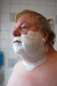 mans face covered in foam ready for his morning shave