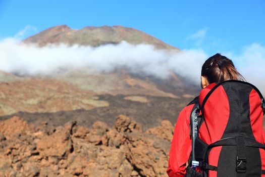 Woman hiking looking at challenges ahead. The peak is Pico Viejo on the volcano Teide, Tenerife.