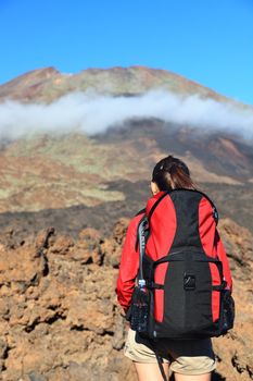 Hiking woman looking at mountain peak. The peak is Pico Viejo on the volcano Teide, Tenerife.