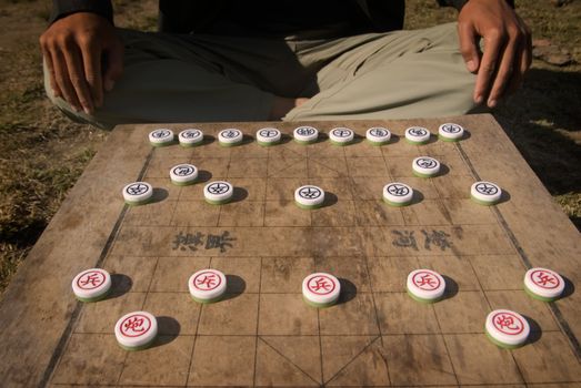 Here are the traditional chinese chess in day.And a man is watting for start.