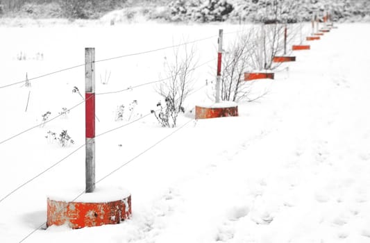 blizzard white-out revealing only orange fencing