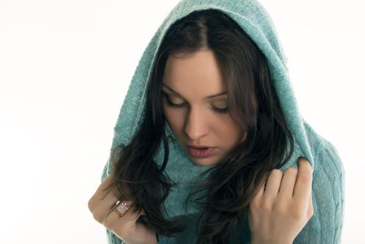 young brunette in hood looking sad and lonely