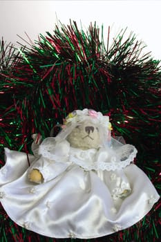 teddy dressed as a bride amongst christmas tinsel