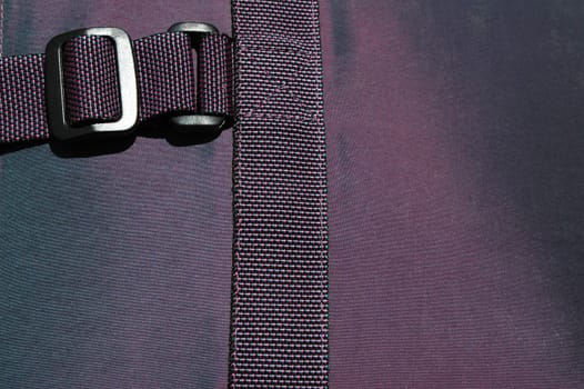 purple fabric background with chrome buckle