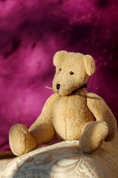soft toy bear sitting on home furnishings