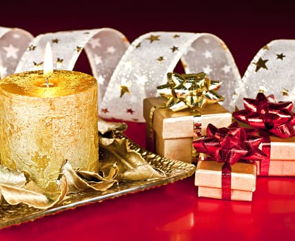 Christmas Decor, on a red background, candles, gift boxes and Bantu with the stars.
