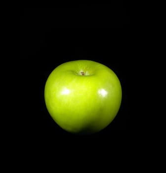 fresh vivid green apple over black background