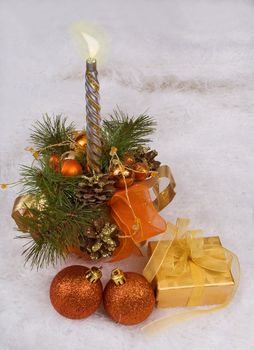 Christmas silver candles and golden box on the white skin
