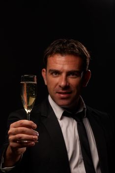 Attractive guy toasting with a glass of champagne