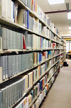 Rows of grey books at the school library, university or college.