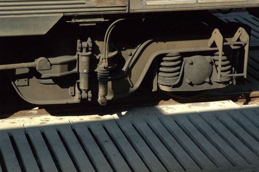 Closeup of train wheels on wooden platform