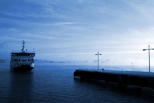 Passenger ferry "Huldra" arrives at Nesoddtangen, Norway, on an icy cold winter morning.