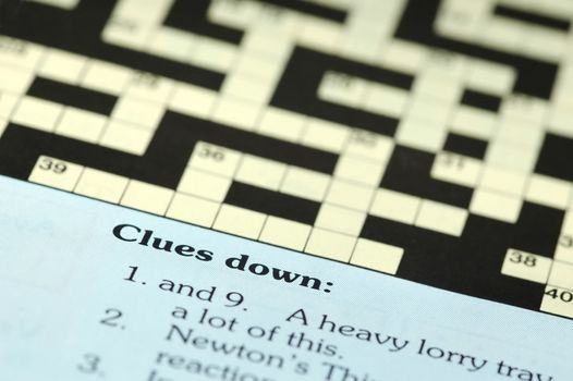 crossword puzzle closeup with clues down 