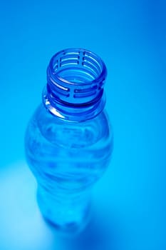 Open plastic bottle on blue background