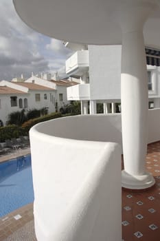 balcony and column support overlooking a swimming pool