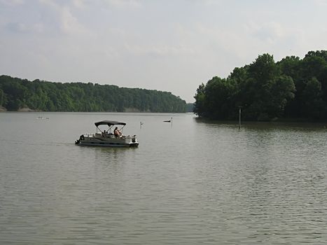 A photograph of a motorized boat on a waterway.