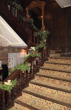 old staircase with carpet and decorated for the christmas season