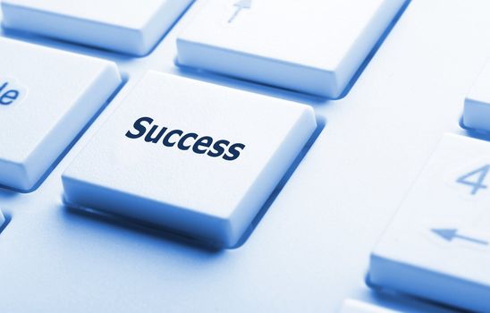 success in business concept with key on computer keyboard