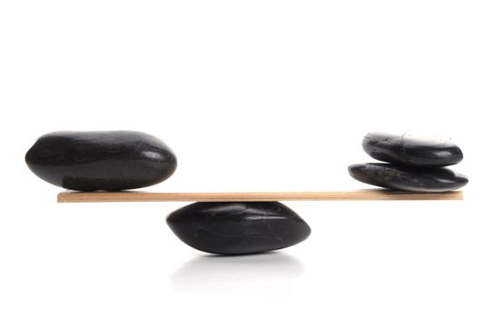 scales with zen stone isolated on white showing balance or spa