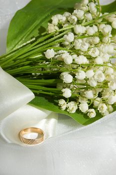 Lily-of-the-valley bouquet with wedding ring