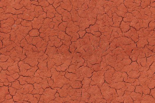 Cracked red textured surface background, seamlessly tileable