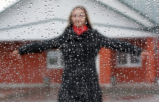 Beautiful girl with red scarf and umbrella for glass with drop of water
