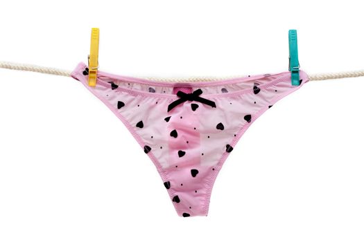 Rose feminine panties subhung on rope colour clothes-peg, isolat