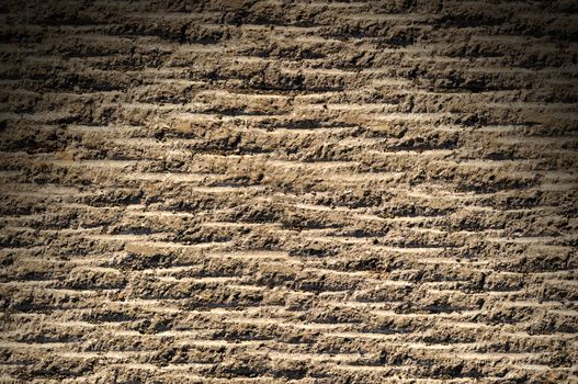 Grooved asphalt or rock surface texture lit from above