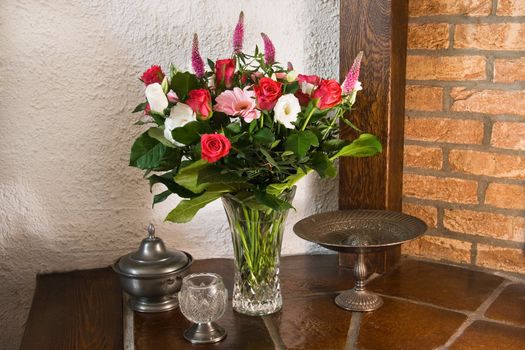 Classic stillife and vase with flowers in red, white and pink