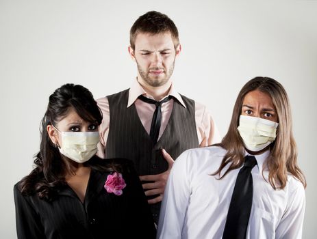 Tall man with stomach upset and coworkers wearing masks