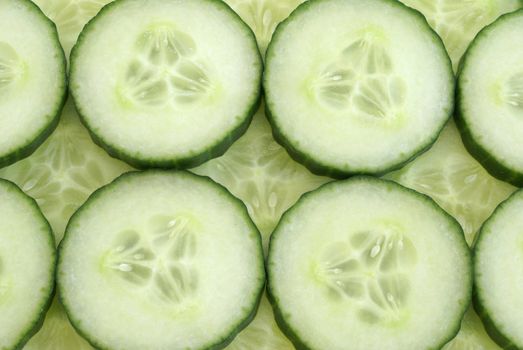 Many cucumber slices filling the frame to create a background.