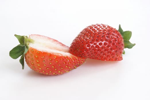 A cut ripe strawberry on white background.
