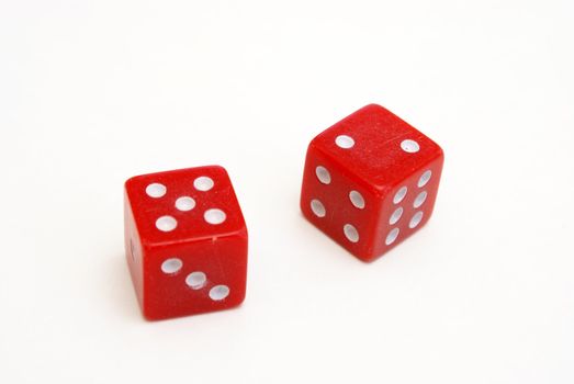 Two red dice on white background with the number five and two showing.