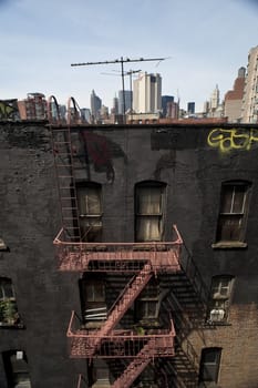 straight on view of exterior steel fire escape on tenement building.  lower east side, new york city